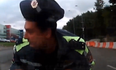 Video: Russian cop gets taken for a ride on the hood of a car