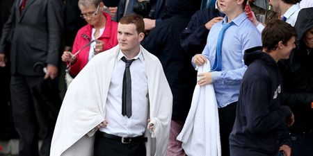 Video: Punter at the Galway Races caught wiping his wet face with a €50 note on live TV