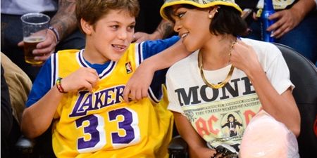 This young lad looked delighted to be sitting next to Rihanna at the Lakers game