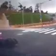 Video: Motorcyclist crashes off bike and then disappears down a hole in the road
