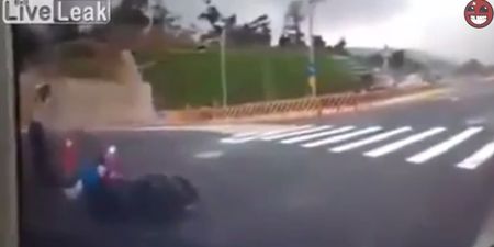 Video: Motorcyclist crashes off bike and then disappears down a hole in the road