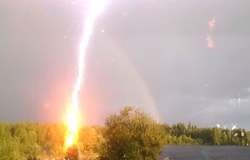 Video: Woman almost gets struck by lightning while admiring rainbow in back garden