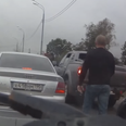 Video: Raged Russian driver turns into pussy cat when confronted by burly dog