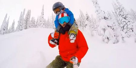 Video: A dad snowboarding down a mountain with his son on his shoulders
