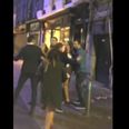 Video: Busker in Galway keeps singing despite a scrap breaking outside beside him