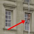 Video: Insane footage of a naked man climbing down the side of Buckingham Palace and falling