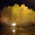 Video: Tractor creates one of the biggest splash waves you’ll ever see while driving through a puddle