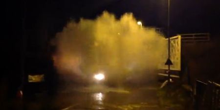 Video: Tractor creates one of the biggest splash waves you’ll ever see while driving through a puddle