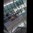 VIDEO: Three lads practicing their rowing skills on the moving walkway at Dublin Airport