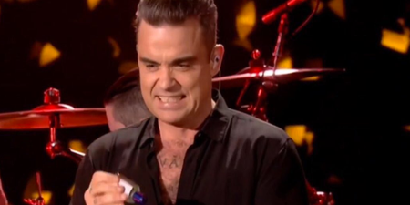 WATCH: Grimacing Robbie Williams uses hand-sanitiser immediately after touching audience at NYE gig
