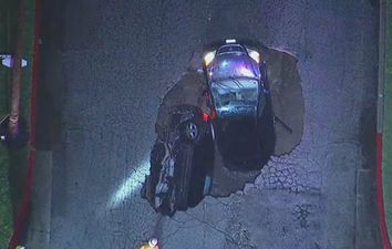 WATCH: Sinkhole swallows two cars in the middle of a deadly California storm
