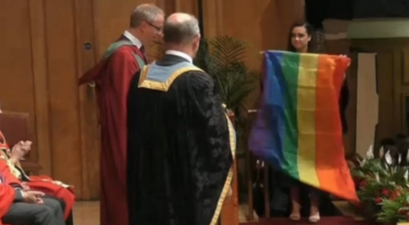 Student in Belfast collects her degree draped in a Pride flag