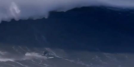 Surfer breaks back as a result of wipeout caused by giant 60-foot wave