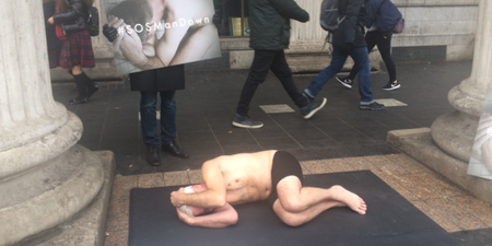 Semi-naked men are laying down in the street to promote men’s mental health awareness