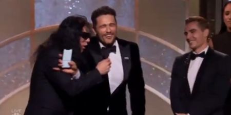 Tommy Wiseau tries to grab the microphone after James Franco’s win at the Golden Globes