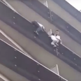 Heroic man climbs up apartment building to save child hanging from balcony