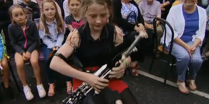 young girl playing uileann pipe class