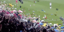 Football fans throw stuffed toys onto pitch for earthquake victims